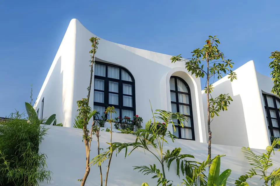 Curved white facade with arched black-framed windows
