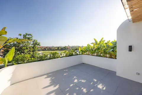 Open rooftop terrace with planters and views over the fields
